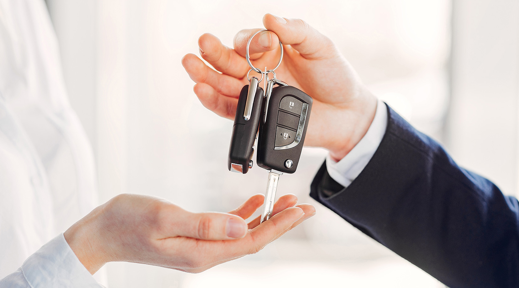 Woman buying the car. Lady in a car salon. Manager with a client